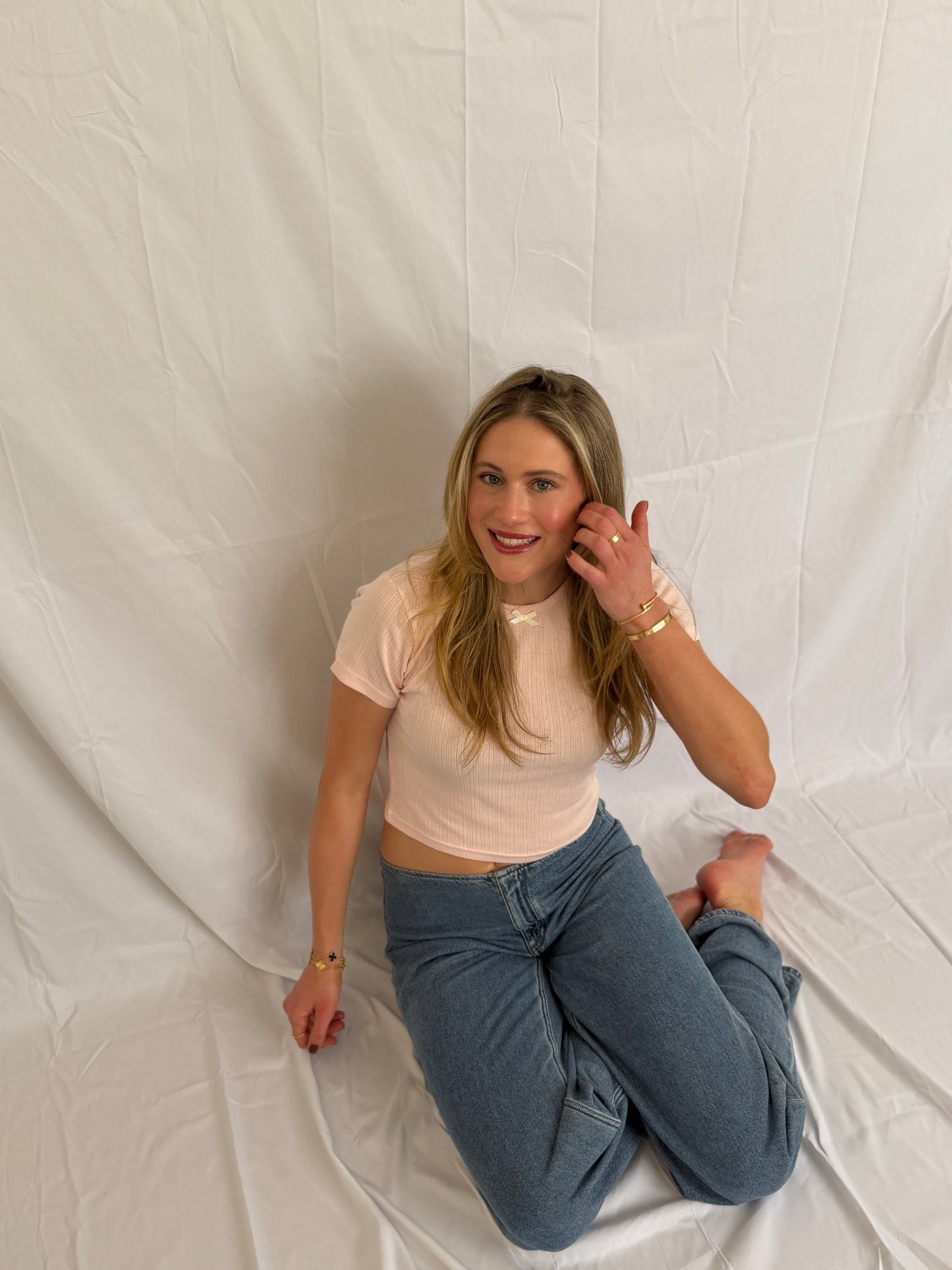 Pointelle Baby Tee in blush pink, embroidered logo detail at the front hem